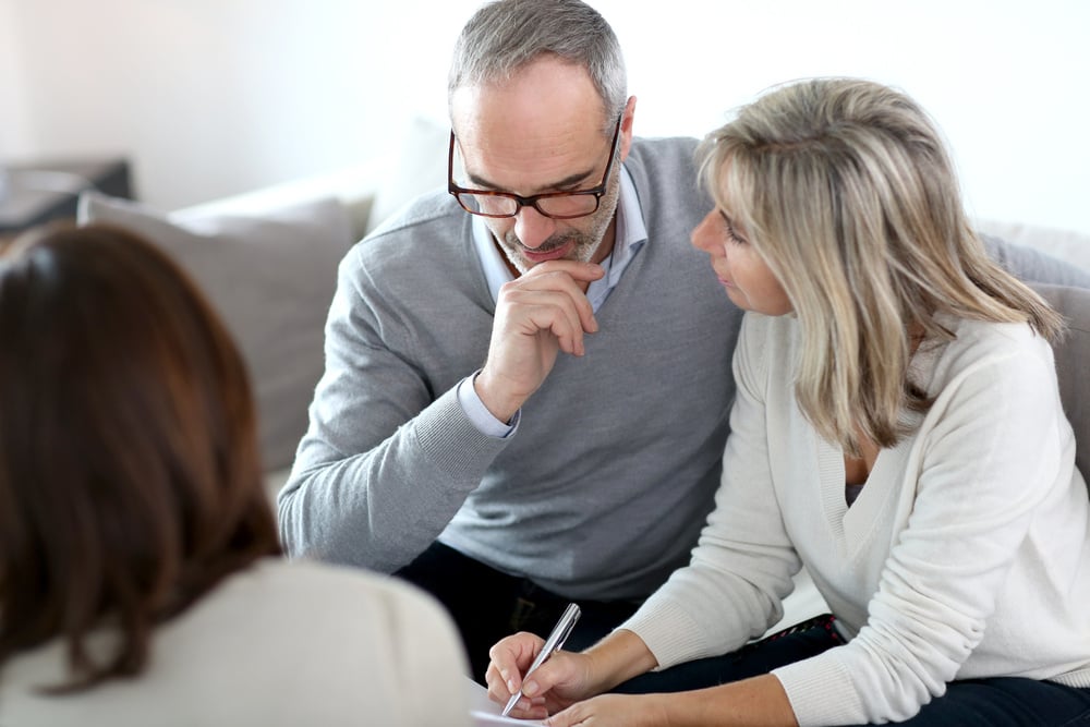 Senior couple meeting financial adviser for investment