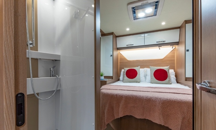 A Burstner TD736 bedroom and shower space