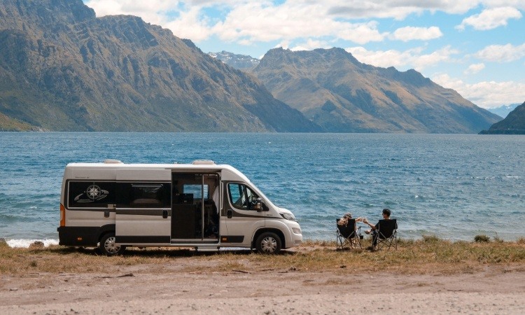 A campervan freedom camping beside a lake