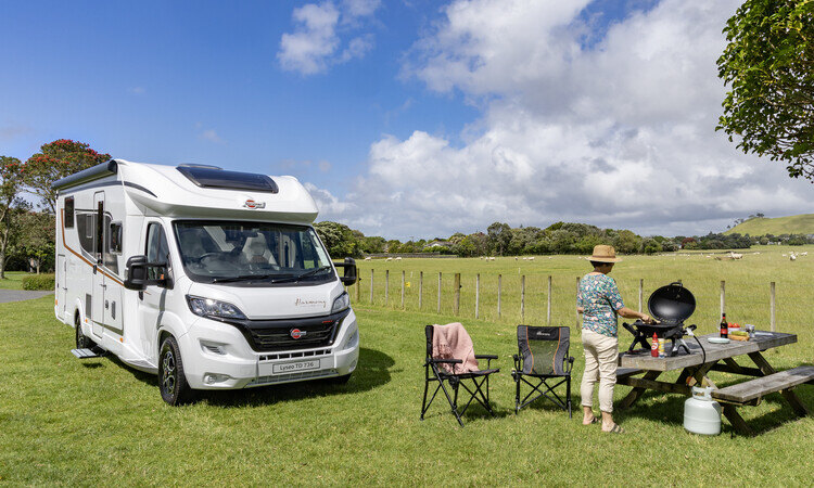 A woman enjoying her time outside of the Burstner Lyseo TD736 motorhome