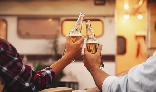 Cheers with beer in front of RV