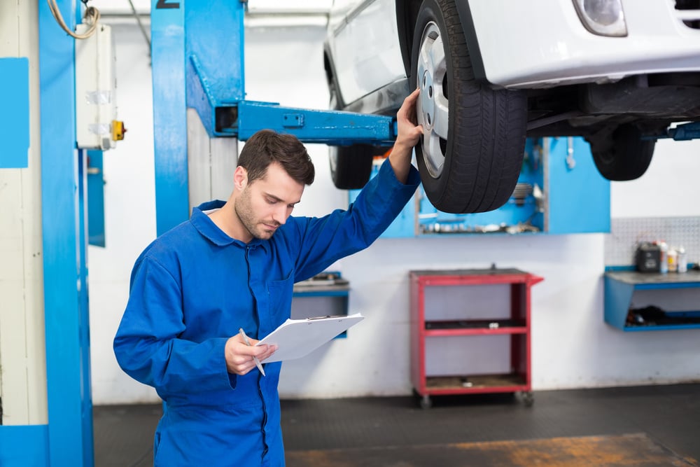 Mechanic inspecting the tyre compliance