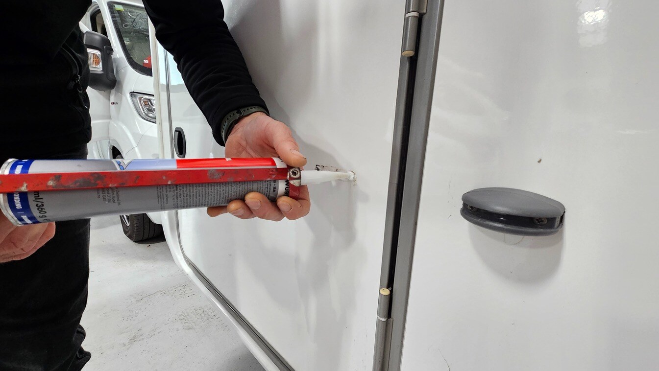 A sealant being used on the exterior of a motorhome