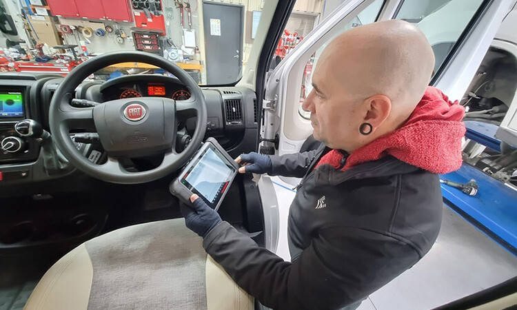 A technician inspecting a motorhome