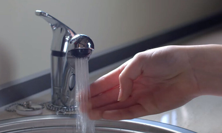 Testing out the water faucet in a motorhome