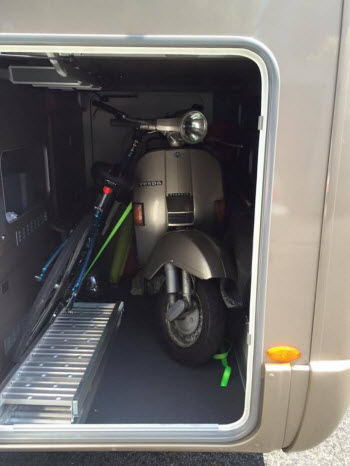 Motorhome’s garage with bike and scooter